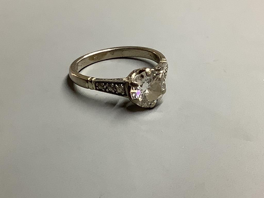 An 18ct, white metal and single stone diamond ring, with diamonds set shoulders, size M, gross weight 3.9 g